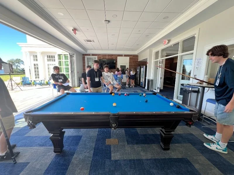students playing pool at opening week