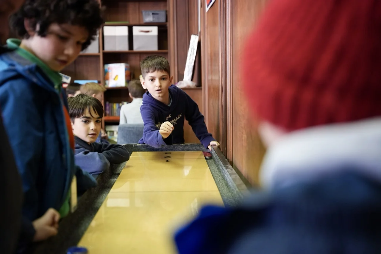 elementary boy playing in game room