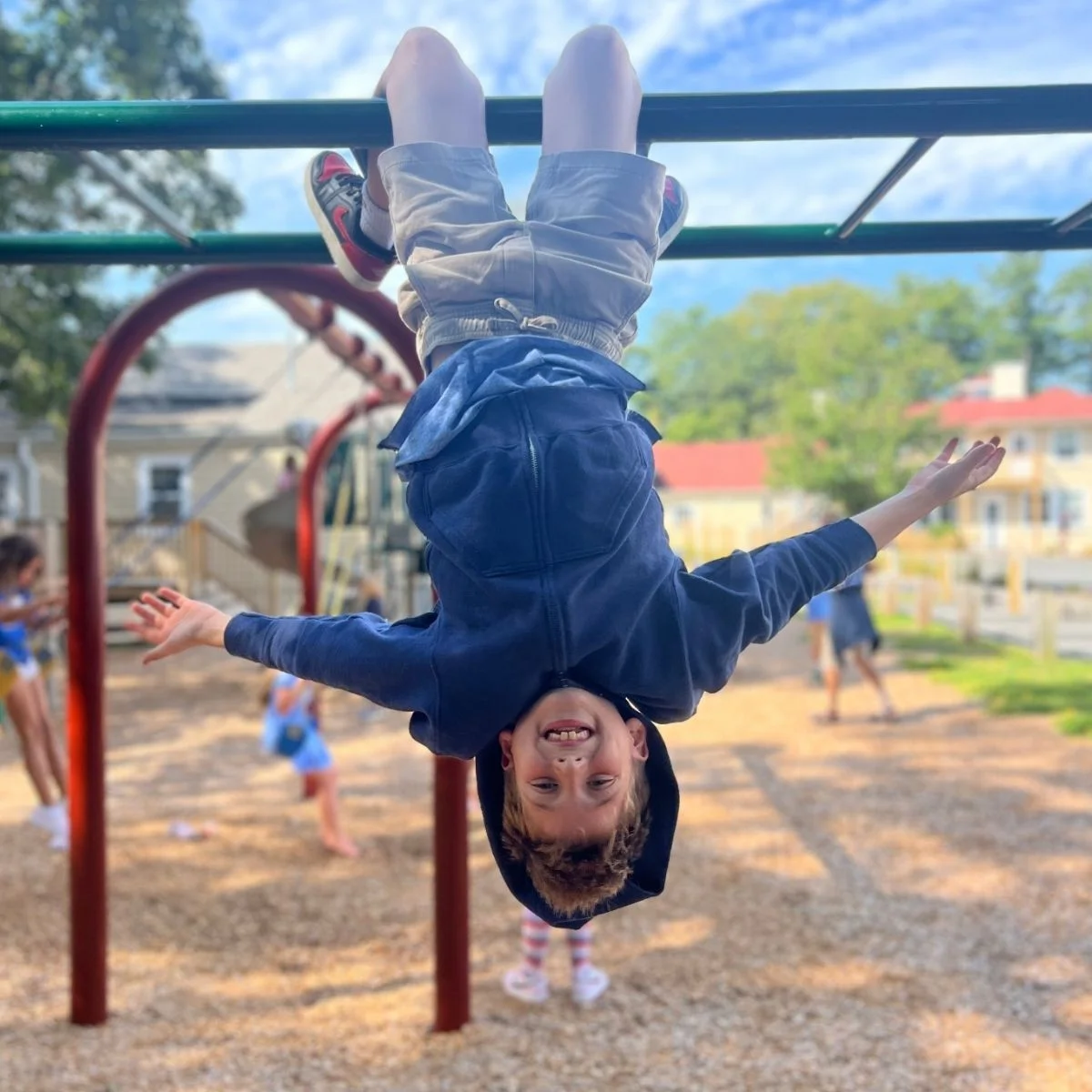 EMs boy on monkey bars on playground