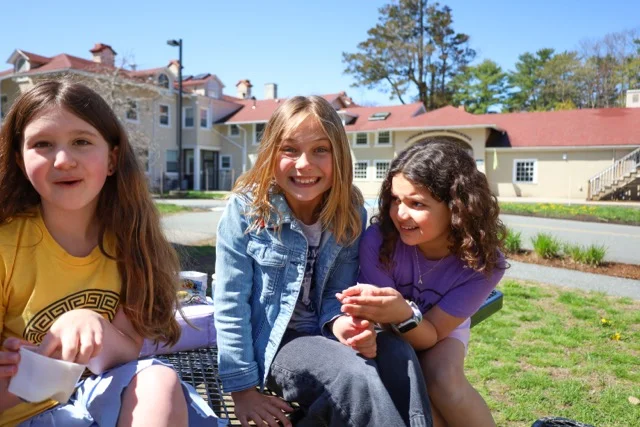 girls hanging on bench eating snacks