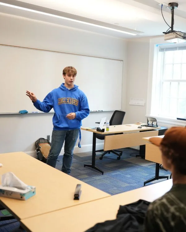 student presenting in front of classroom