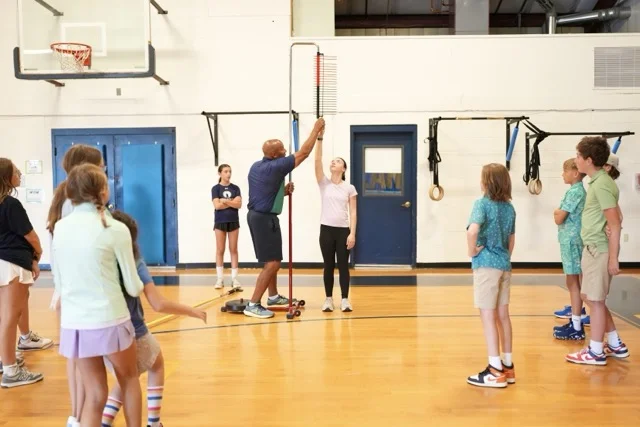 students learning a skill in gym class