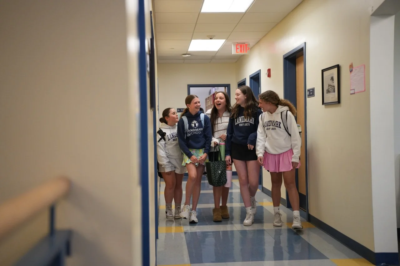 girls walking down hallway