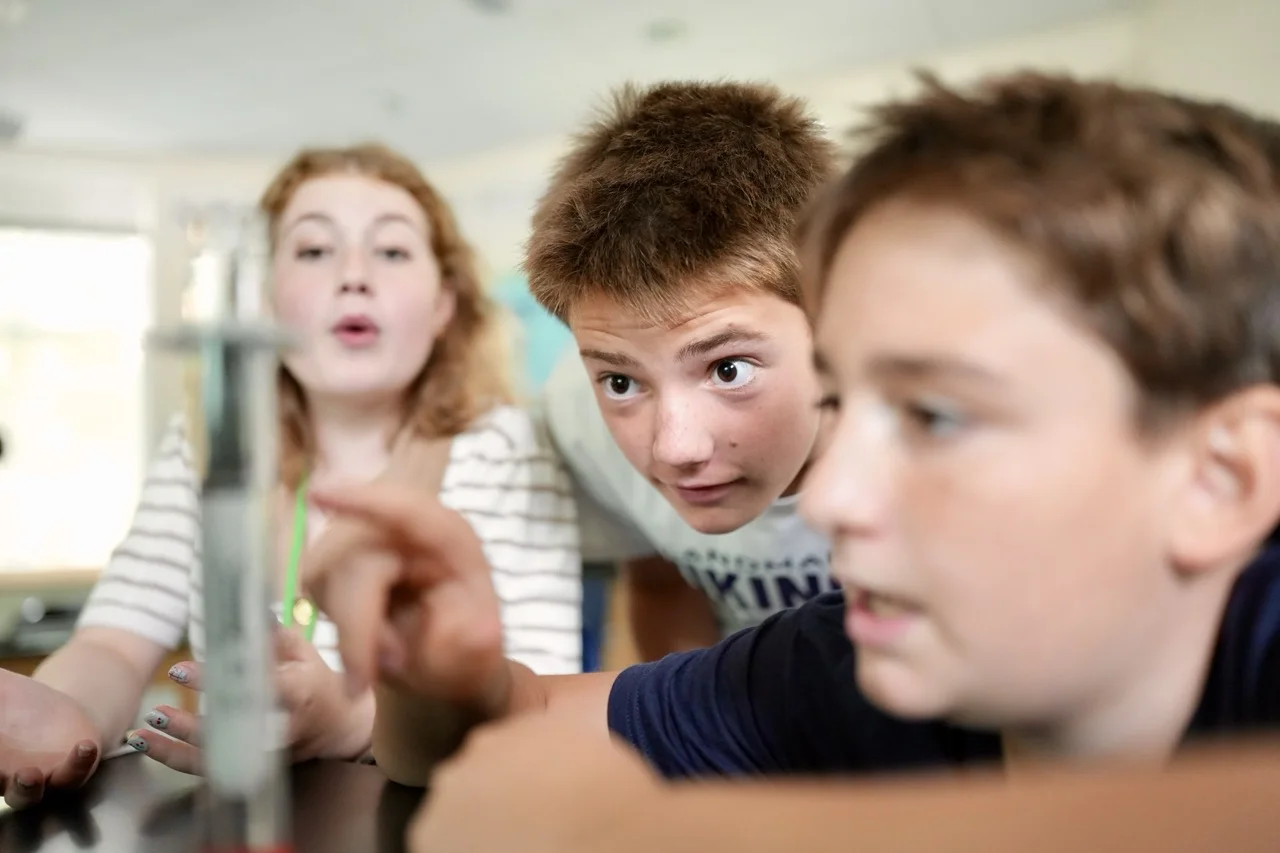 three middle school students talking about science project