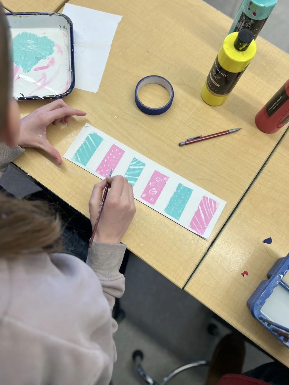 girl painting in middle school art