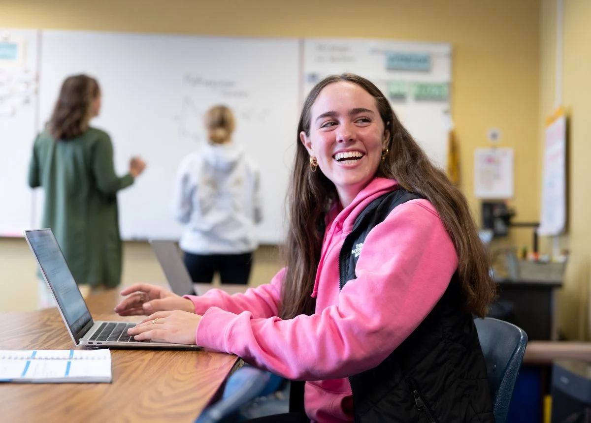 high school student smiling at table