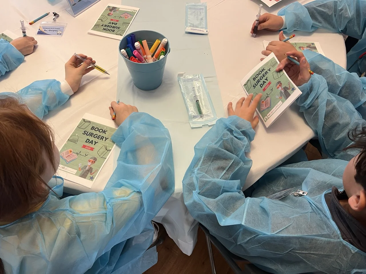 students dissect books for their parts in a book surgery hands on learning event