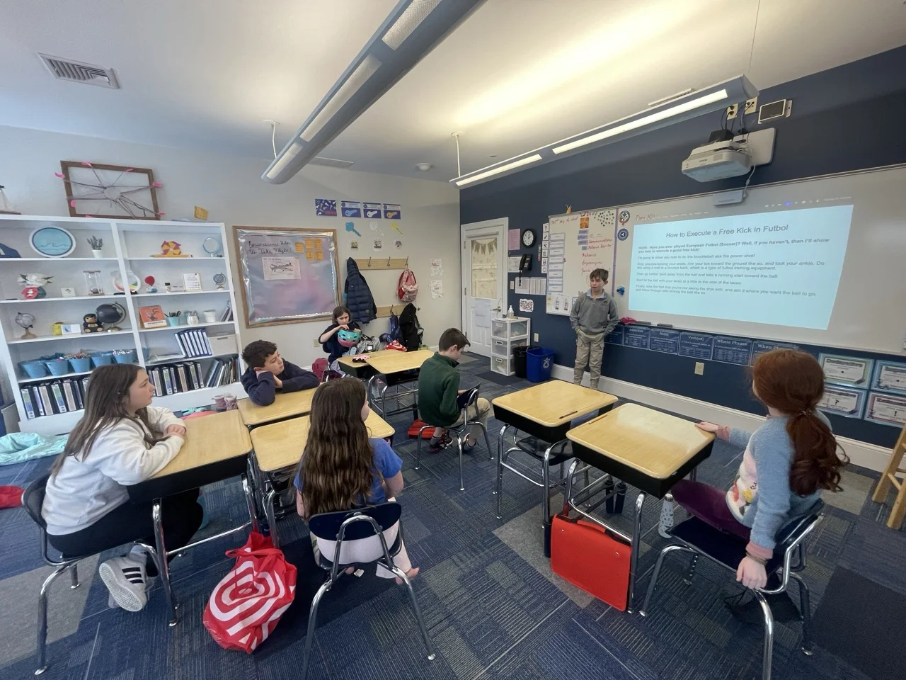 student presenting in front of small class