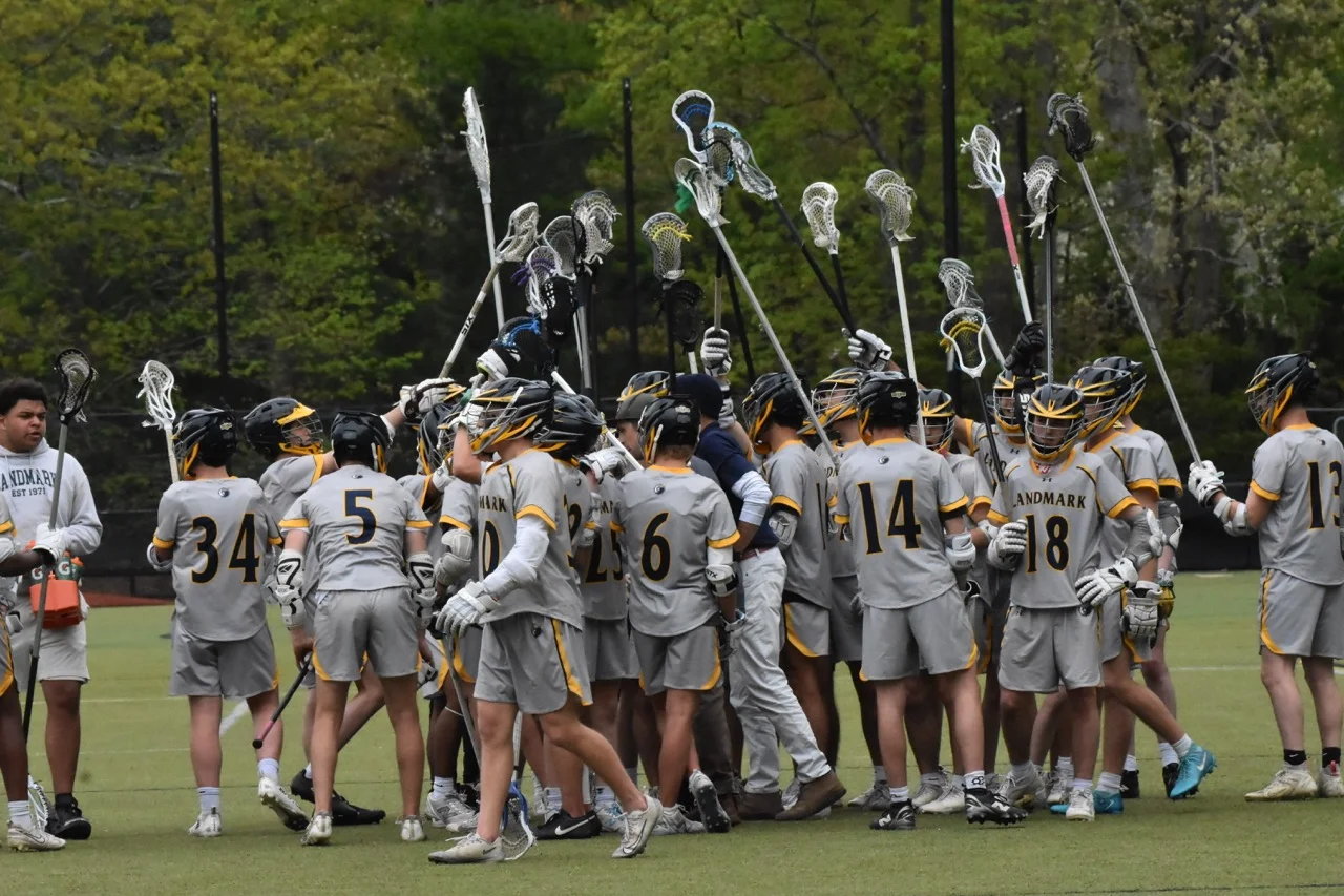 boys lacrosse in huddle