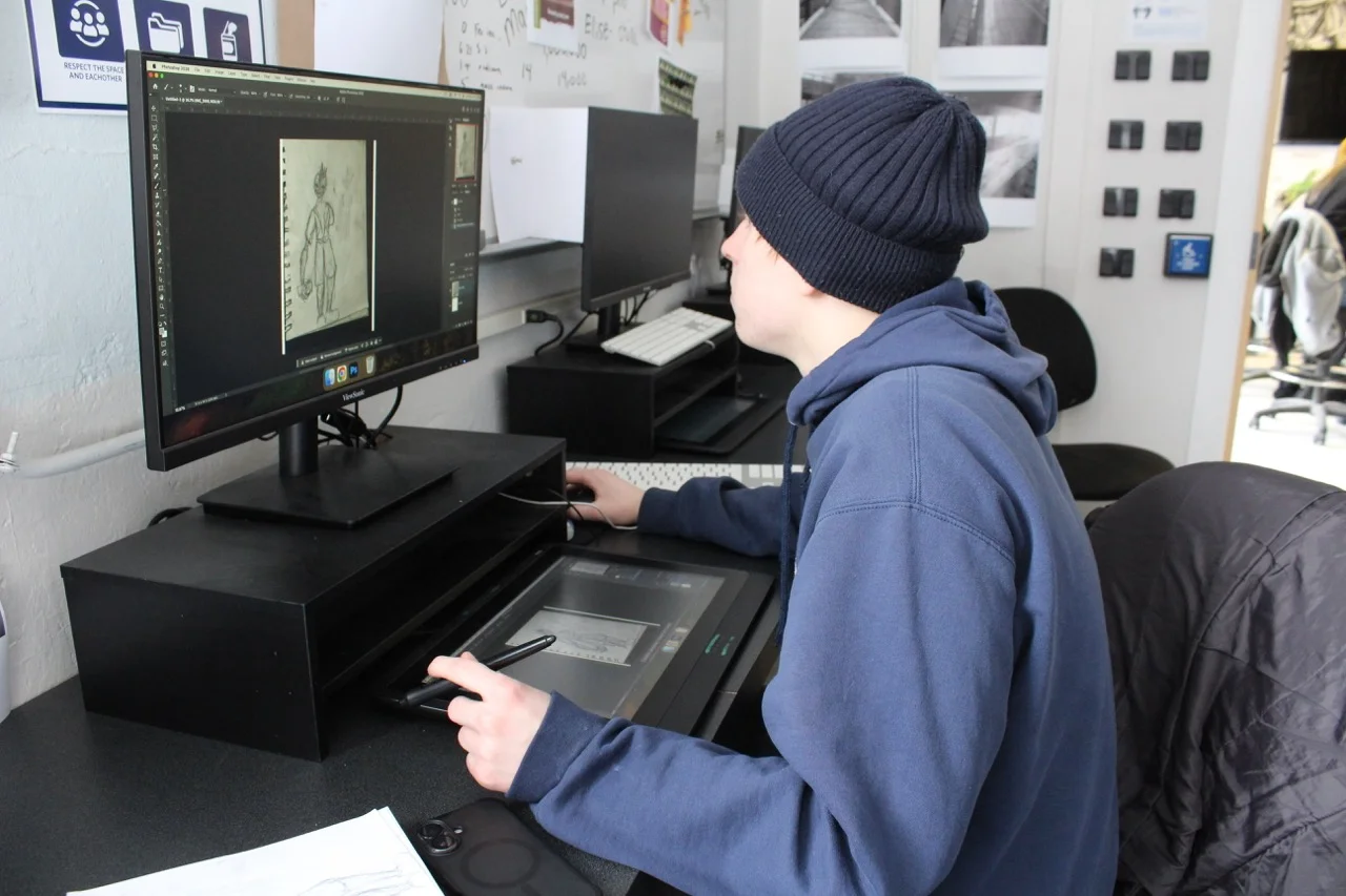digital art and design student working on project on computer working on literacy skills by following step by step directions
