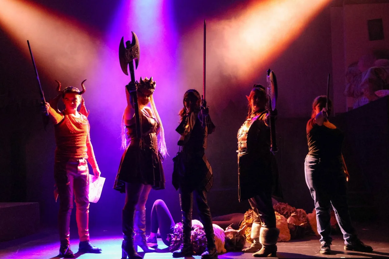students in play on stage