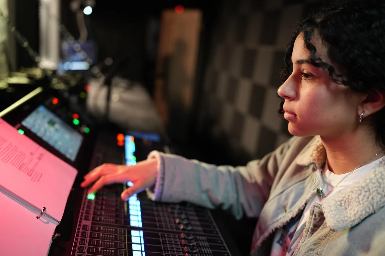 student at sound board in tech box