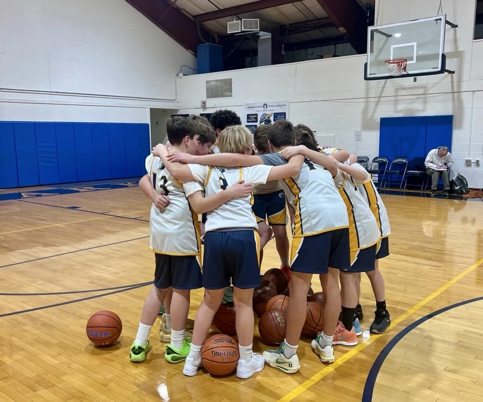 middle school basketball in huddle