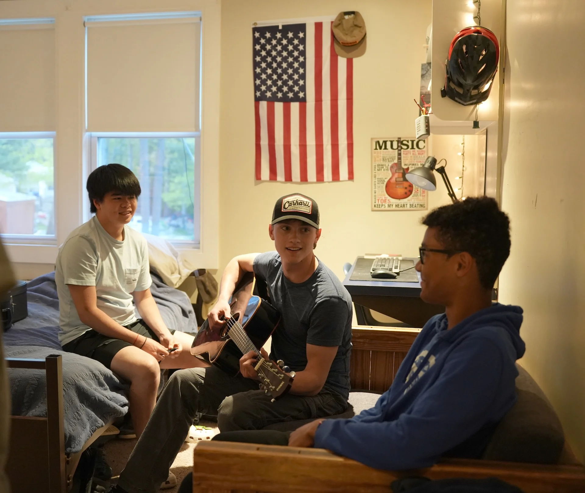 students playing guitar in dorm room
