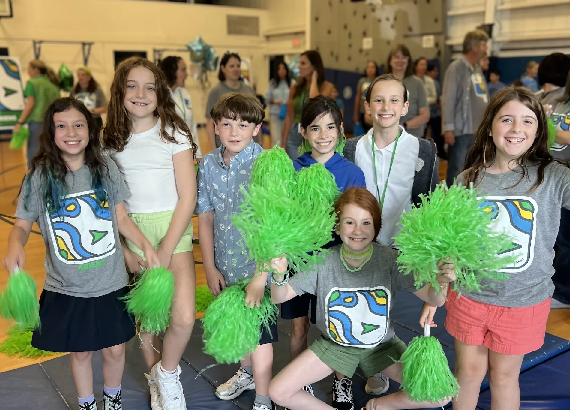 girls in ems house system with green poms