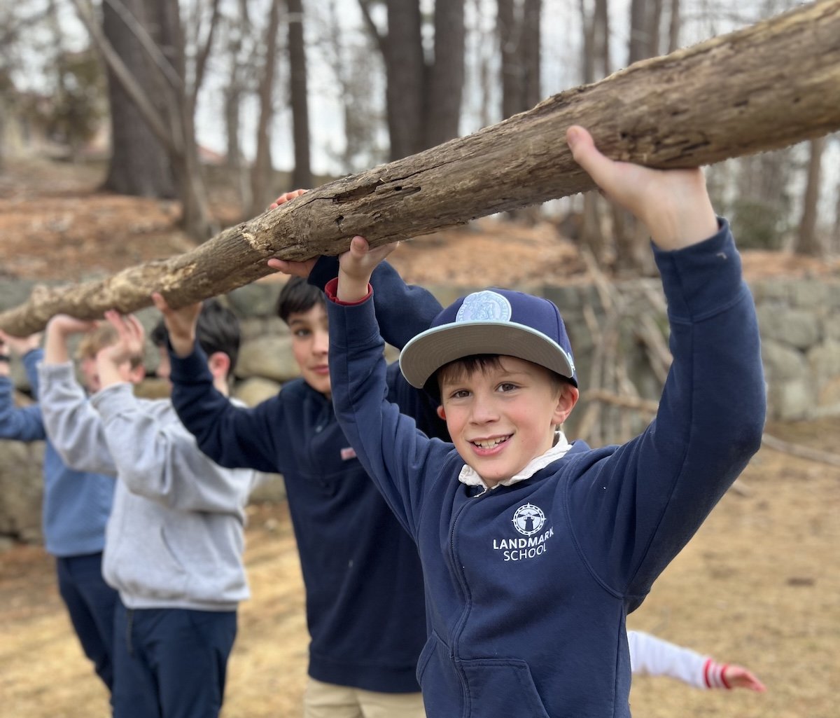 kids playing outside with logs