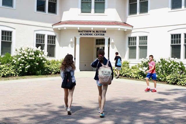 EMS courtyard students with backpacks
