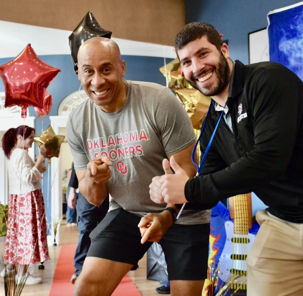 staff members at appreciation event giving thumbs up
