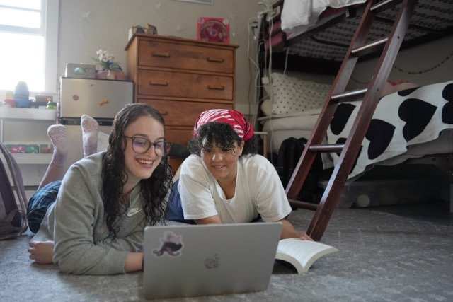 girls working and hanging out in dorm room