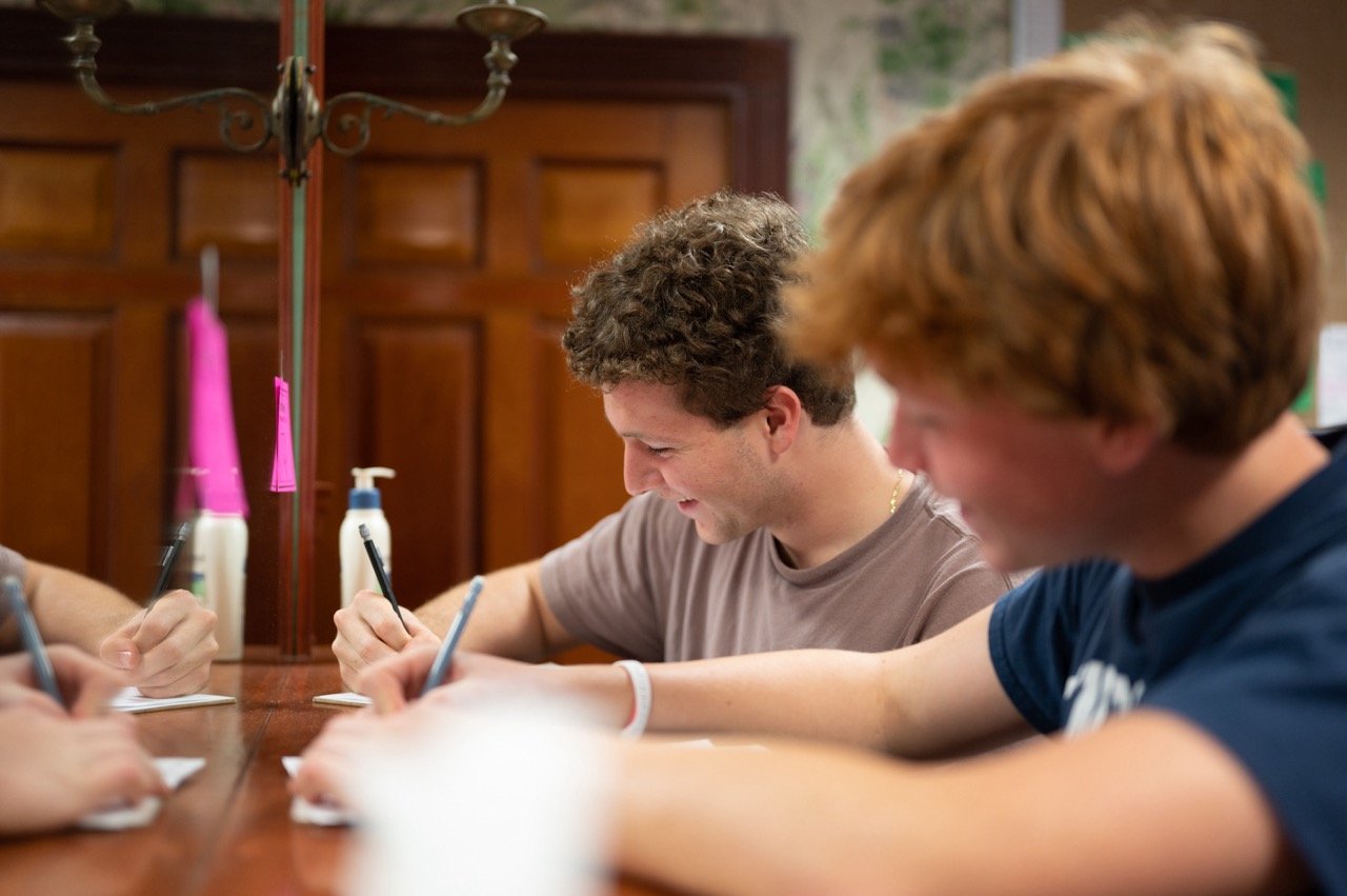 boys brainstorming and working on assignment together