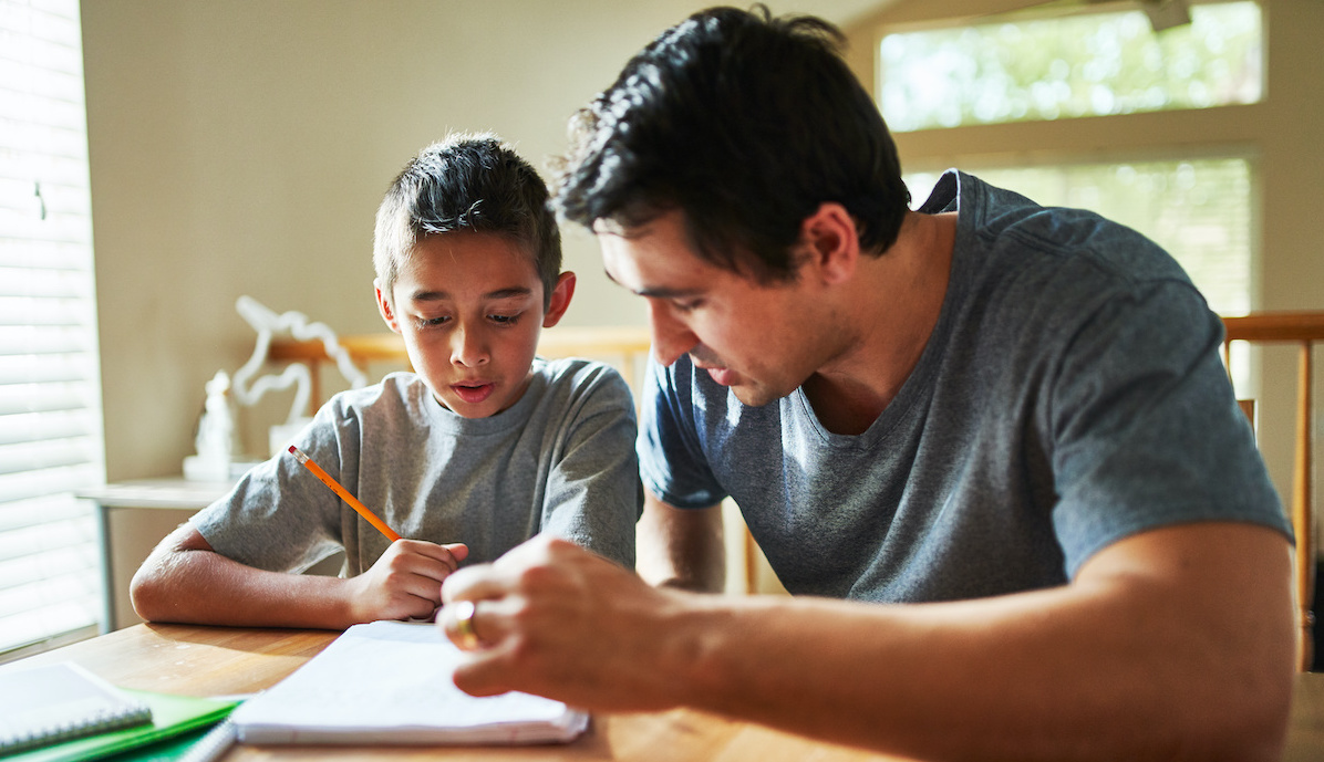 father and son doing homework