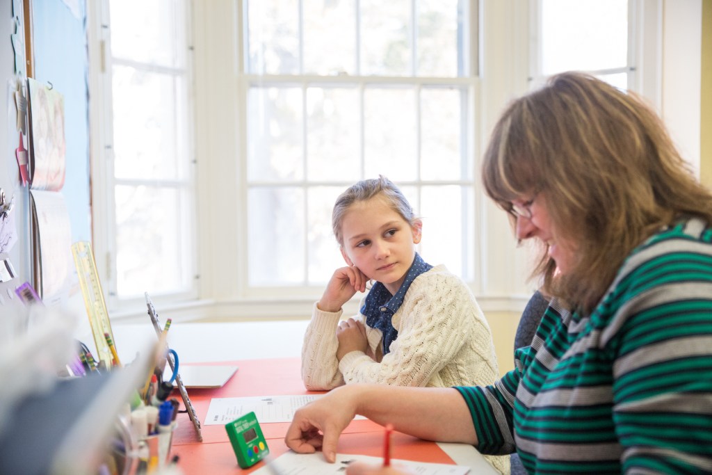 teacher working with student