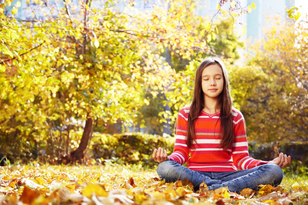 girl meditating serene location