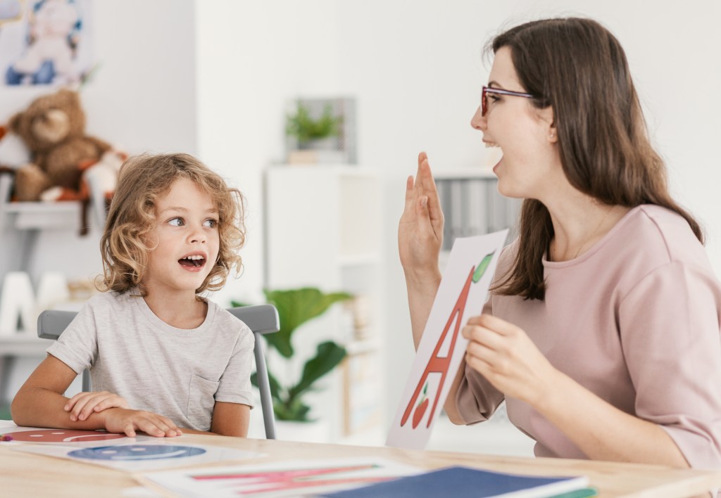 teacher doing phonics with student