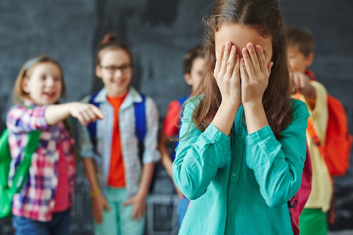 girls laughing at others