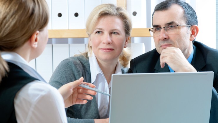 parents talking to person with computer