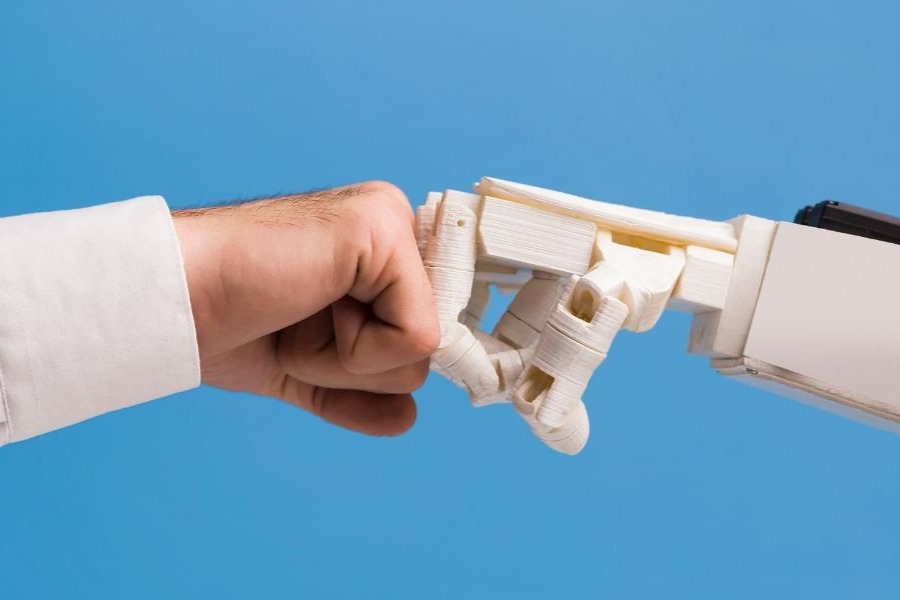 fist bump of human and robot or AI