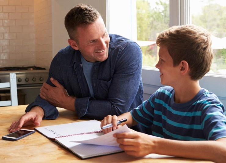 father and son at table with list