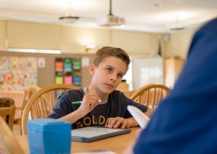 boy learning at table