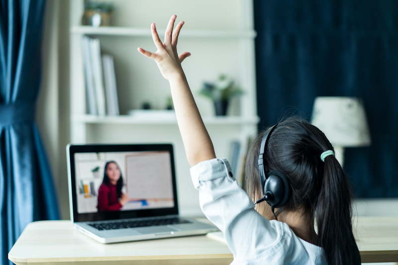 girl raising hand remote class