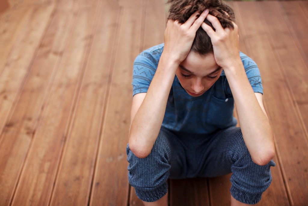 middle school aged boy showing stress