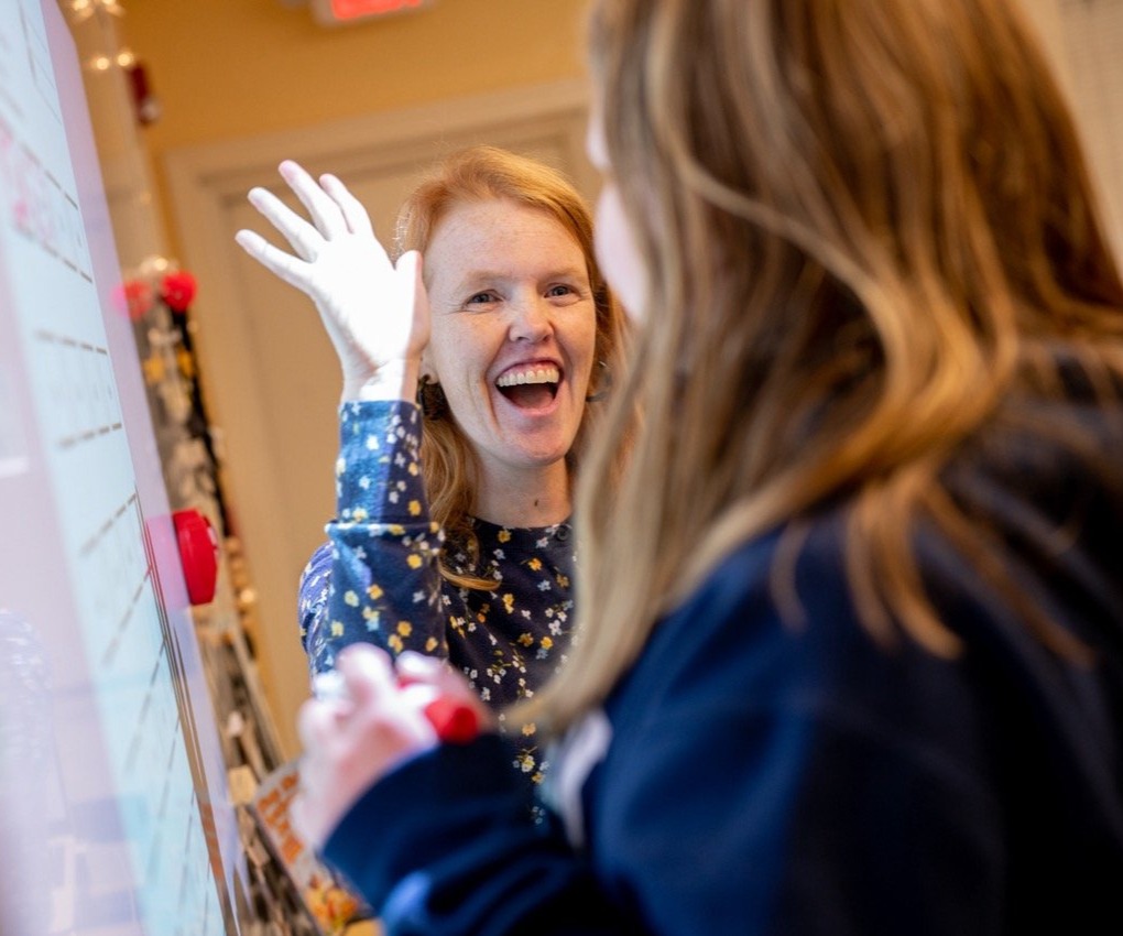 teacher high fiving student
