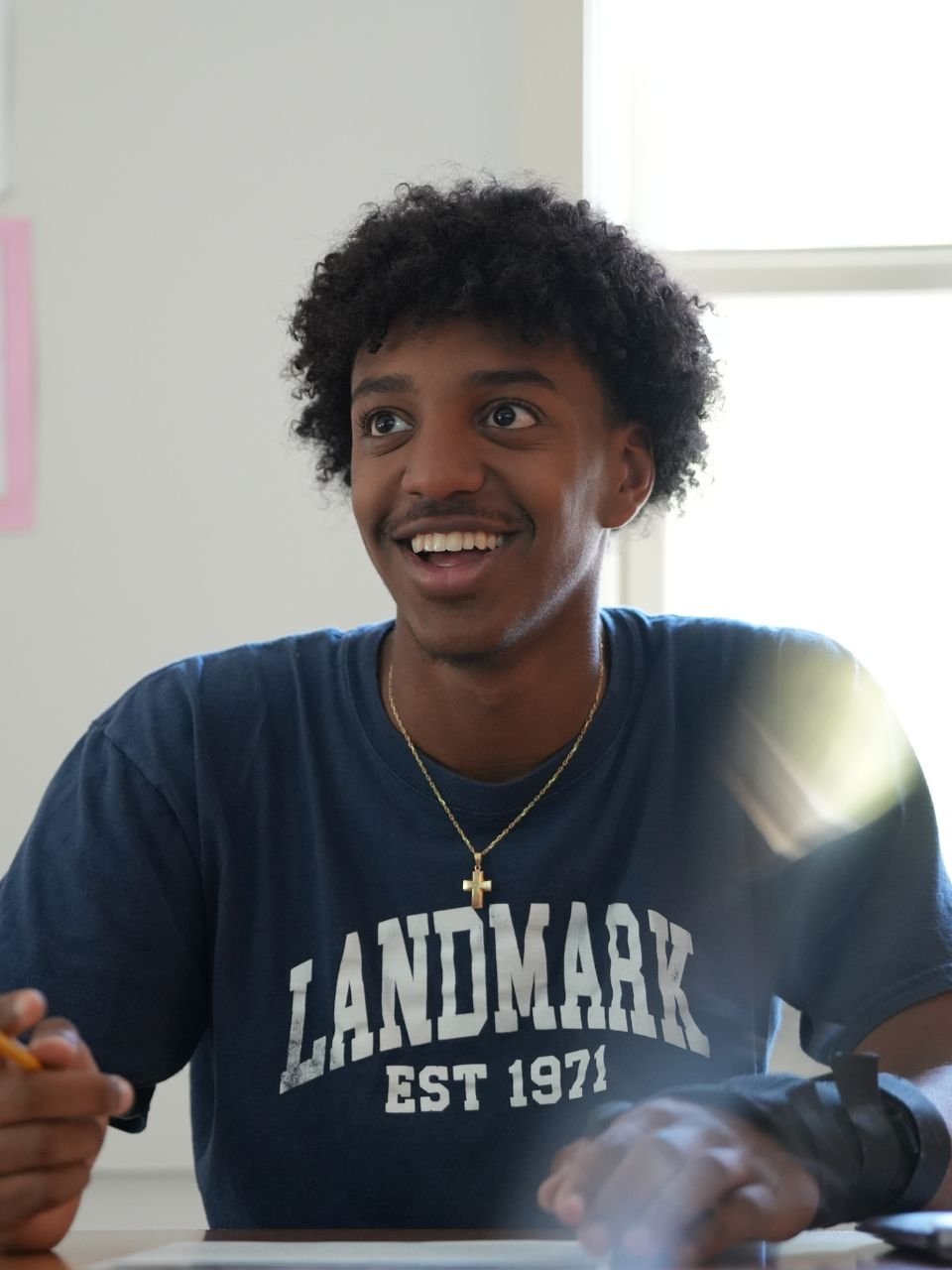 student in class smiling