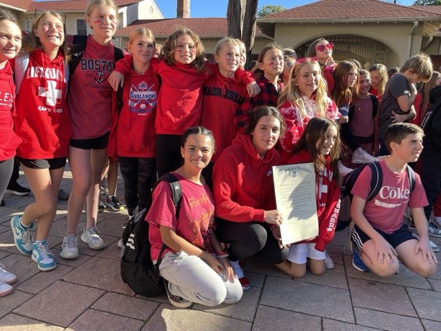 students holding dyslexia awareness legislation and wearing red