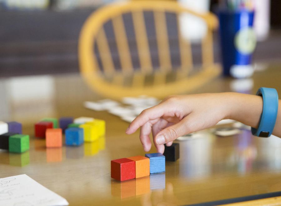 student's hand with blocks