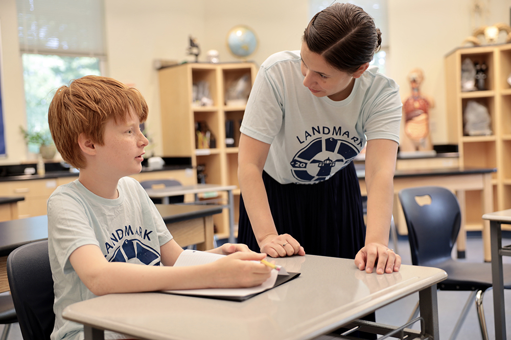 student with teacher in classroom